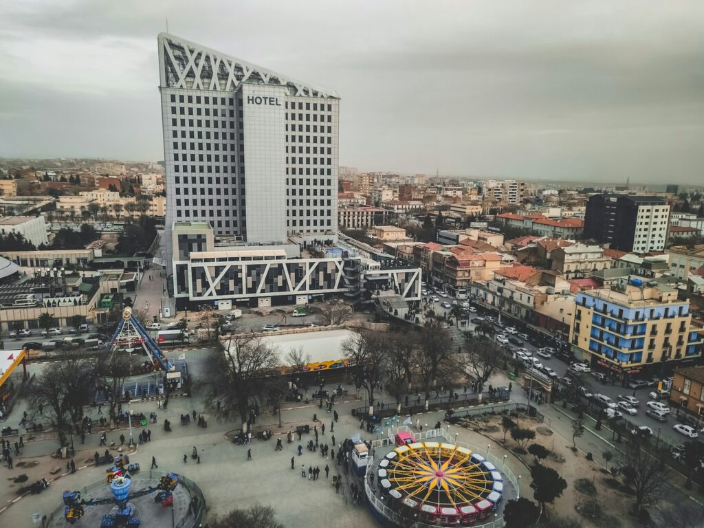 an aerial view of a city with a ferris wheel